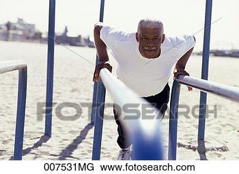 Stock Photo - senior man standing 
at parallel bars. 
fotosearch - search 
stock photos, 
pictures, images, 
and photo clipart