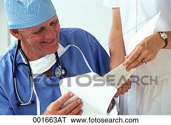 Stock Photo - surgeon looking 
at chart with 
a nurse. fotosearch 
- search stock 
photos, pictures, 
images, and photo 
clipart