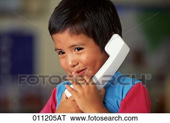 Stock Photo - close-up of a 
young hispanic 
boy talking on 
a telephone. fotosearch 
- search stock 
photos, pictures, 
images, and photo 
clipart