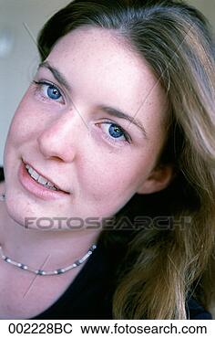 Stock Photo - young woman with 
her head tilted, 
close-up. fotosearch 
- search stock 
photos, pictures, 
images, and photo 
clipart