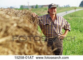 Stock Photo - a middle-aged 
adult caucasian 
male farmer in 
a field leaning 
against. fotosearch 
- search stock 
photos, pictures, 
images, and photo 
clipart