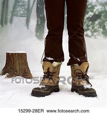 Stock Photo - woman legs wearing 
snow boots, standing 
by woods on snowy 
winter day. fotosearch 
- search stock 
photos, pictures, 
images, and photo 
clipart