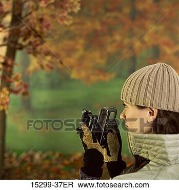 Stock Photo - woman taking photo 
with camera, in 
autumn forest, 
headshot. fotosearch 
- search stock 
photos, pictures, 
images, and photo 
clipart