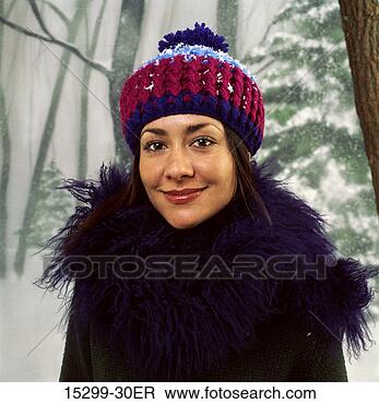 Stock Photo - woman in winter 
hat standing by 
woods on snowy 
winter day. fotosearch 
- search stock 
photos, pictures, 
images, and photo 
clipart