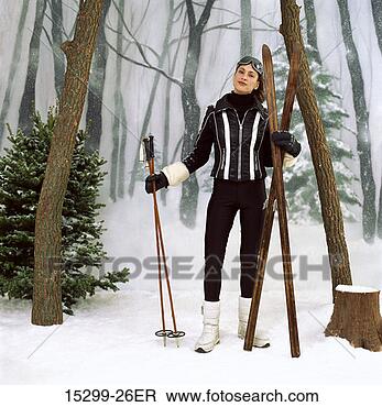 Stock Photo - woman with wooden 
cross-country 
skis, by woods 
on snowy winter 
day. fotosearch 
- search stock 
photos, pictures, 
images, and photo 
clipart