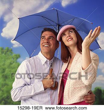 Stock Photo - couple under umbrella, 
on spring day. 
fotosearch - search 
stock photos, 
pictures, images, 
and photo clipart