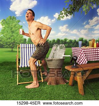 Stock Photo - shirtless man 
cooling off by 
big block of ice 
at picnic,  on 
hot. fotosearch 
- search stock 
photos, pictures, 
images, and photo 
clipart