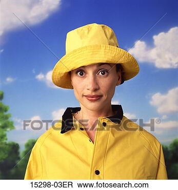 Stock Photo - woman in yellow 
slicker raincoat 
and hat with blue 
sky and clouds. 
fotosearch - search 
stock photos, 
pictures, images, 
and photo clipart