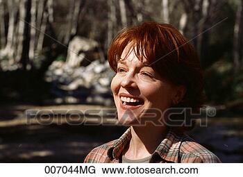 Stock Photo - smiling woman 
in the woods. 
fotosearch - search 
stock photos, 
pictures, images, 
and photo clipart
