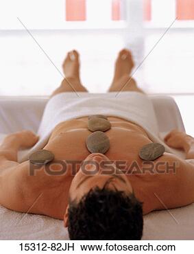 Stock Photo - man getting hot 
stone massage 
treatment. fotosearch 
- search stock 
photos, pictures, 
images, and photo 
clipart