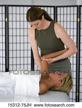 Stock Photo - masseuse massaging 
woman's arm. fotosearch 
- search stock 
photos, pictures, 
images, and photo 
clipart