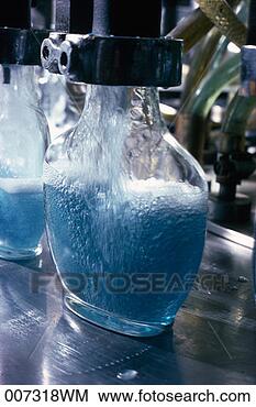 Stock Photo - machinery filling 
glass bottle with 
liquid. fotosearch 
- search stock 
photos, pictures, 
images, and photo 
clipart