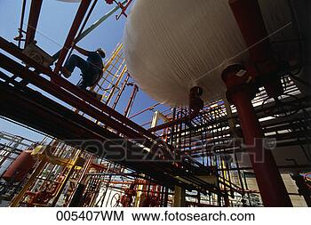 Stock Photo - man kneeling on 
pipes at a chemical 
plant. fotosearch 
- search stock 
photos, pictures, 
images, and photo 
clipart