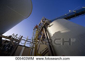 Stock Photo - man at the top 
of an enclosed 
ladder along side 
a large tank at 
a. fotosearch 
- search stock 
photos, pictures, 
images, and photo 
clipart