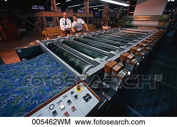 Stock Photo - men monitoring 
cloth being printed 
at a textile mill. 
fotosearch - search 
stock photos, 
pictures, images, 
and photo clipart