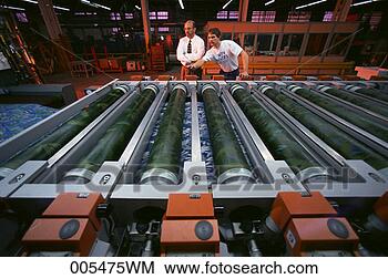 Stock Photo - men monitoring 
cloth being printed 
at a textile mill. 
fotosearch - search 
stock photos, 
pictures, images, 
and photo clipart