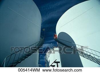 Stock Photo - men standing on 
stairway on large 
storage tanks 
at a refinery. 
fotosearch - search 
stock photos, 
pictures, images, 
and photo clipart