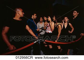 Stock Photo - a small group 
of young latino 
adults waiting 
outside of a nightclub. 
fotosearch - search 
stock photos, 
pictures, images, 
and photo clipart