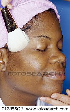 Stock Photo - african-american 
woman having powder 
applied to her 
face, headshot. 
fotosearch - search 
stock photos, 
pictures, images, 
and photo clipart