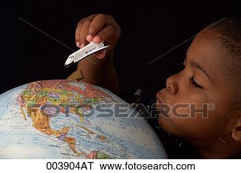 Stock Photo - boy moving toy 
space shuttle 
around a globe. 
fotosearch - search 
stock photos, 
pictures, images, 
and photo clipart