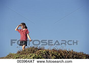 Stock Photo - girl with hand 
to her forehead 
looking over hillside. 
fotosearch - search 
stock photos, 
pictures, images, 
and photo clipart