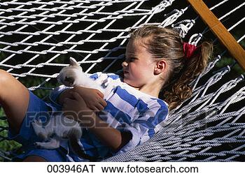 Stock Photo - girl resting in 
a hammock with 
a kitten. fotosearch 
- search stock 
photos, pictures, 
images, and photo 
clipart