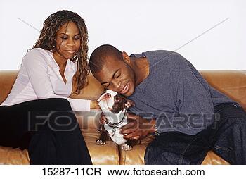 Stock Photo - couple on sofa 
with dog. fotosearch 
- search stock 
photos, pictures, 
images, and photo 
clipart