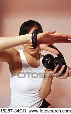 Stock Photo - woman holding 
black snake. fotosearch 
- search stock 
photos, pictures, 
images, and photo 
clipart