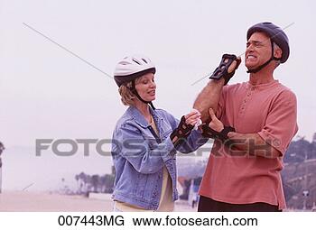 Stock Photo - couple in-line 
skating, woman 
cleaning man's 
injured elbow. 
fotosearch - search 
stock photos, 
pictures, images, 
and photo clipart