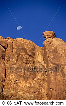 Stock Photo - early moon in 
the sky over a 
rock wall in arches 
national park, 
utah. fotosearch 
- search stock 
photos, pictures, 
images, and photo 
clipart
