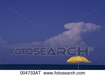 Stock Photo - beach umbrella 
against ocean 
horizon. fotosearch 
- search stock 
photos, pictures, 
images, and photo 
clipart