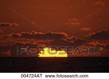 Stock Photo - sun setting into 
the ocean. fotosearch 
- search stock 
photos, pictures, 
images, and photo 
clipart