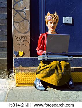 Stock Photo - young woman with 
laptop computer 
sitting on step 
in doorway of. 
fotosearch - search 
stock photos, 
pictures, images, 
and photo clipart