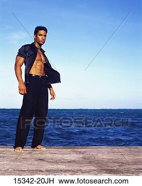 Stock Photo - man in open black 
shirt and black 
pants,  standing 
on ocean pier. 
fotosearch - search 
stock photos, 
pictures, images, 
and photo clipart