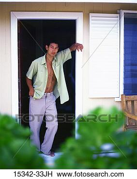 Stock Photo - man with open 
shirt standing 
in doorway of 
hotel room, belize. 
fotosearch - search 
stock photos, 
pictures, images, 
and photo clipart