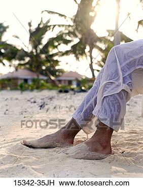 Stock Photo - man's bare feet 
and wet pant legs 
on beach, belize. 
fotosearch - search 
stock photos, 
pictures, images, 
and photo clipart