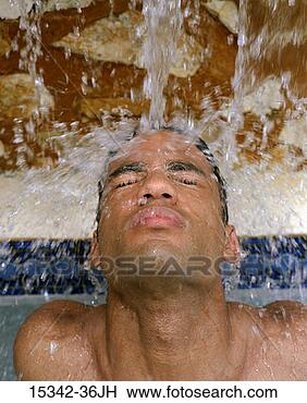 Stock Photo - man's face under 
falling water 
in pool. fotosearch 
- search stock 
photos, pictures, 
images, and photo 
clipart