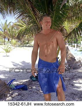 Stock Photo - man with towel 
wrapped around 
his waist,  standing 
under palm tree 
on. fotosearch 
- search stock 
photos, pictures, 
images, and photo 
clipart