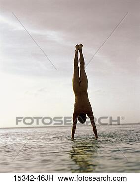 Stock Photo - nude man doing 
handstand in ocean, 
belize. fotosearch 
- search stock 
photos, pictures, 
images, and photo 
clipart