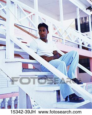 Stock Photo - serious man sitting 
on steps of hotel, 
belize. fotosearch 
- search stock 
photos, pictures, 
images, and photo 
clipart