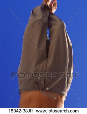 Stock Photo - shirtless man's 
lower body falling, 
 upside down with 
blue sky. fotosearch 
- search stock 
photos, pictures, 
images, and photo 
clipart