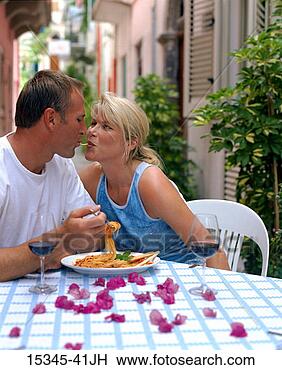 Stock Photo - prime couple eating 
the same spaghetti 
noodle as they 
dine at outdoor. 
fotosearch - search 
stock photos, 
pictures, images, 
and photo clipart