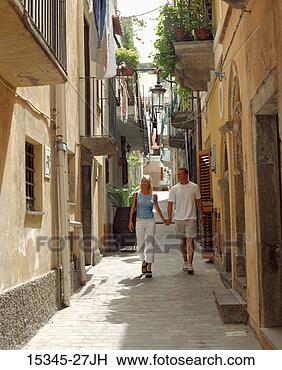 Stock Photo - prime couple sightseeing 
and  holding hands 
as the walk along 
narrow. fotosearch 
- search stock 
photos, pictures, 
images, and photo 
clipart