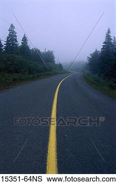 Stock Photo - curving road with 
solid yellow 