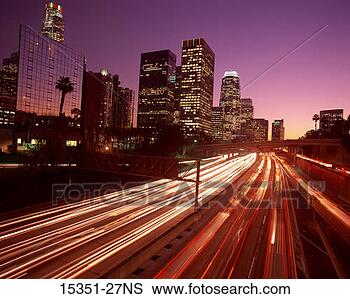 Stock Photo - lights streaks 
from traffic at 
night along highway 
with skyscrapers. 
fotosearch - search 
stock photos, 
pictures, images, 
and photo clipart