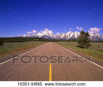 Stock Photo - open road leading 
to grand teton 
mountains, wyoming, 
usa. fotosearch 
- search stock 
photos, pictures, 
images, and photo 
clipart