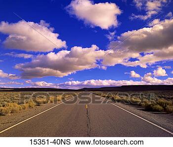 Stock Photo - open road through 
barren landscape 
leading to distant 
mountains. fotosearch 
- search stock 
photos, pictures, 
images, and photo 
clipart