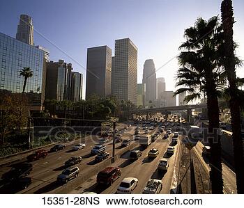 Stock Photo - traffic on highway 
with palm trees 
and skyscrapers, 
 los angeles. 
fotosearch - search 
stock photos, 
pictures, images, 
and photo clipart