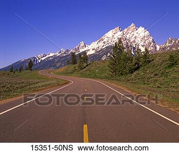 Stock Photo - winding highway 
and snow-covered 
mountains, grand 
tetons, wyoming, 
usa. fotosearch 
- search stock 
photos, pictures, 
images, and photo 
clipart