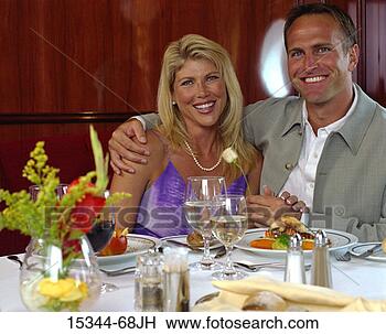 Stock Photo - prime couple embracing, 
sitting at dining 
table in ship's 
dining room. fotosearch 
- search stock 
photos, pictures, 
images, and photo 
clipart